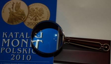 Pozłacana lupa firmy Leuchtturm na drewnianym stojaku